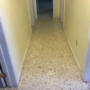 Finished hallway of daycare with speckled floor.