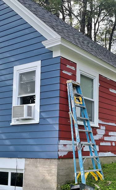 Residential exterior painting in process.