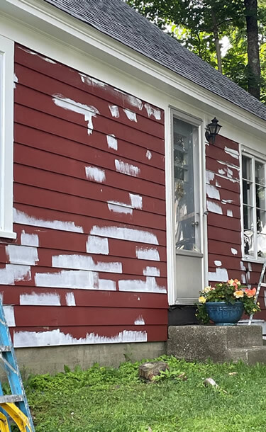 Residential exterior painting before changing the color of the home from red to blue