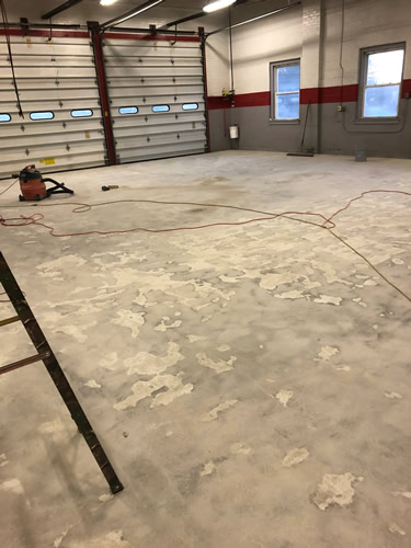 Unfinished garage floor.