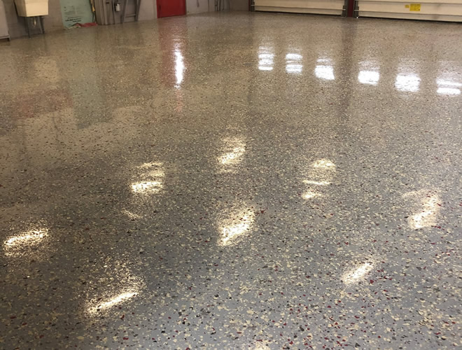 Finished garage floor with multi-colored speckles.