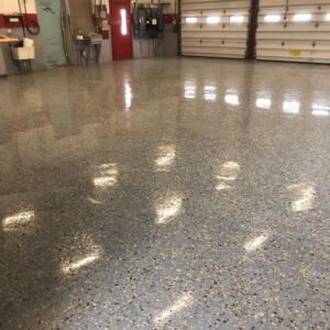 Commercial garage with gray, white, black and red speckled floor.