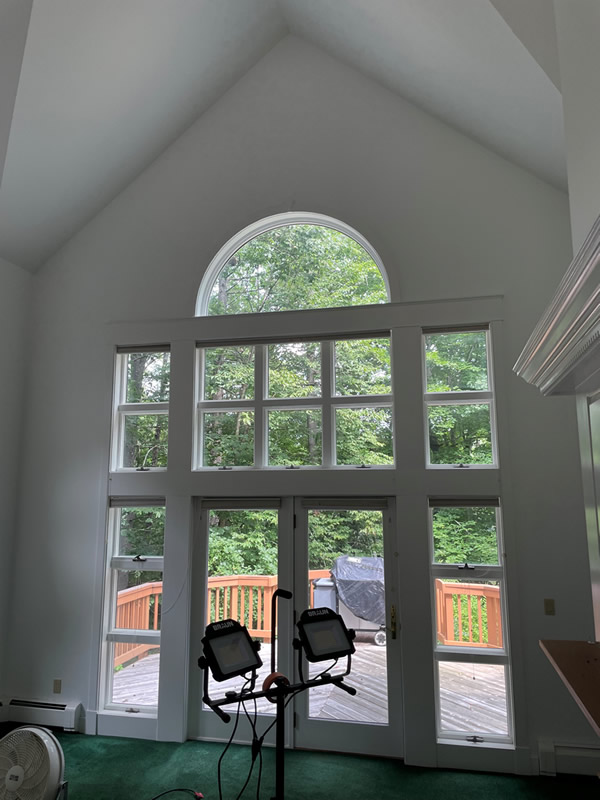 Interior painting of a great room with a cathedral ceiling.